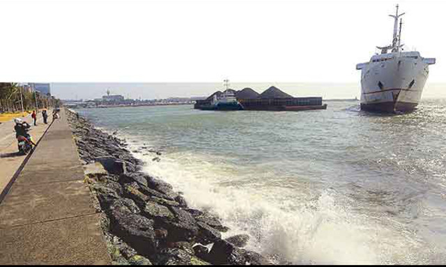 Ferry, barge and a tug blown aground by typhoon in Manila Bay