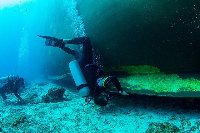 A diver checks on the base portion of grounded MV Belle Rose in Monad Shoal