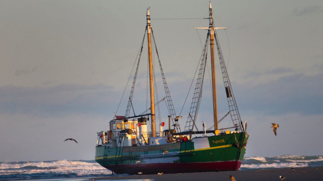 Historic ship runs aground in river mouth in New Zealand; later completely demolished