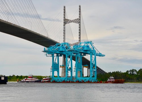 Large Jaxport container cranes move by barge up St. Johns River