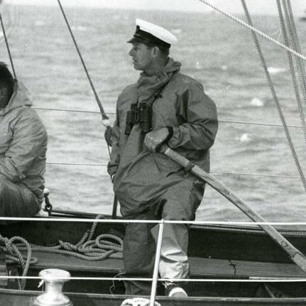 Prince Philip in yachting cap and oilskins at the helm of the Royal racing yacht the 34 ton yawl Bloodhound
