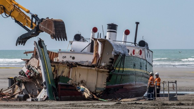 The historic ship MV Tuhoe is pulled apart at the mouth of the Waimakariri River. 