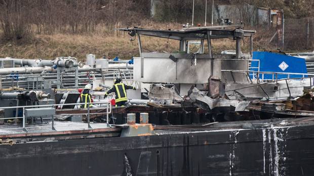 Firefighters on board a tanker which exploded in the Duisburg shipyard in western Germany