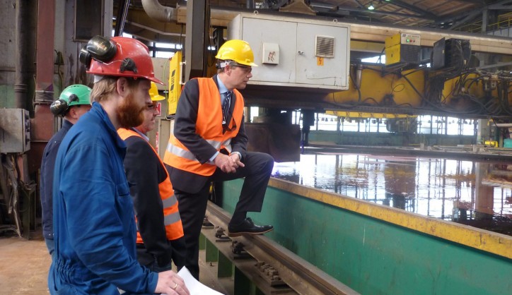 Steel cutting marks the production start of a shipbuilding project, here closely watched by Ulstein Verft and Color Line representatives.